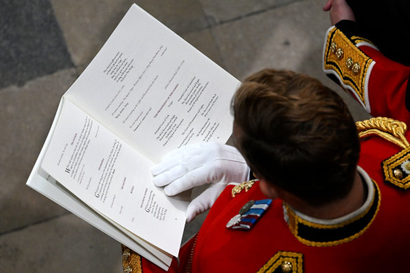 A guest reads the order of service.