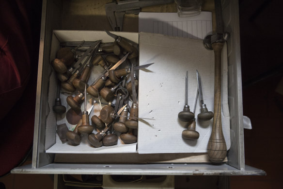 Engraving accessories and tools in a workshop drawer.
