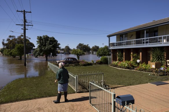 Jayne Whitworth at the front of her home as floodwater recedes in Forbes.