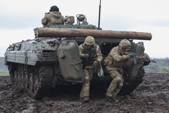 Ukrainian soldiers leave their APC during training at the frontline in Donetsk region, Ukraine.