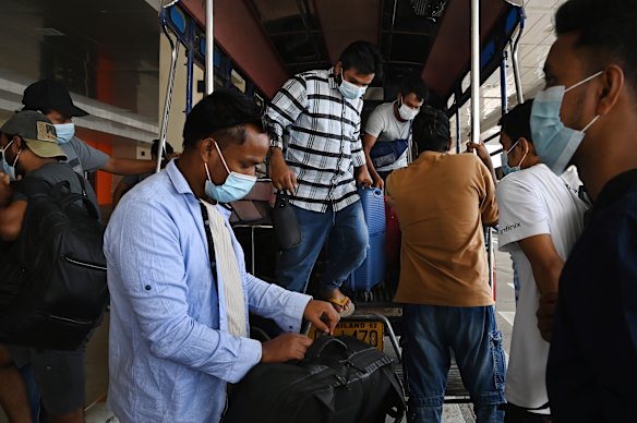 A group of Bangladeshi men, who were freed from the scam factories of Myanmar, arrive at Mae Sot airport before flying home.