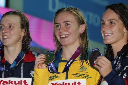 Australian gold medallist Ariarne Titmus, centre, stands with silver medallist United States' Katie Ledecky and her compatriot and bronze medallist Leah Smith after the 400m freestyle final at the World Swimming Championships in Gwangju.