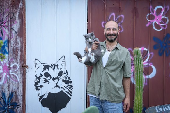 Ashkan Teymouri, 36, with cat Mini.