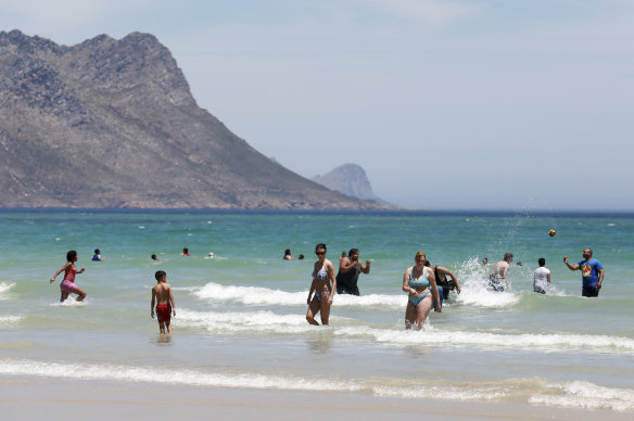 Holdiaymakers enjoy a sweltering day at Strand Beach near Cape Town, South Africa on Tuesday.