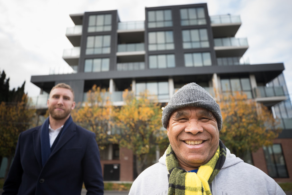 Armindo De Olizeara (right) outside his new home at a social housing development in Footscray, with Unison acting CEO James King.CREDIT:JASON SOUTH