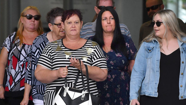 The family and friends of victim Shane Merrigan are seen at the Supreme Court in Brisbane, Thursday.