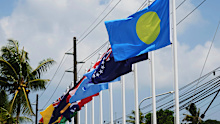 Flags of member states fly outside the summit venue for the Pacific Islands Forum Leaders Meeting in Koror, Palau.