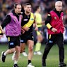 Dion Prestia is helped from the field in the clash against the Cats.
