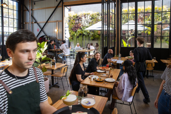 Campground Kitchen, housed in a tin-roofed warehouse, includes a dog-friendly patio framed by a vertical garden. 