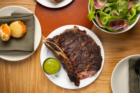 Rib-eye steak, spanner crab arepa and butter lettuce salad with cucumber and shallots on the menu at Morena.