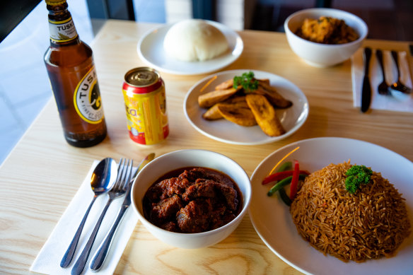 Assorted dishes at Little Lagos, featuring jollof rice, goat stew and fried plaintains.