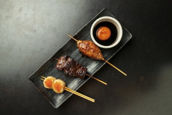 A platter with tsukune (chicken meatball), wagyu and scallop skewers at Robata.