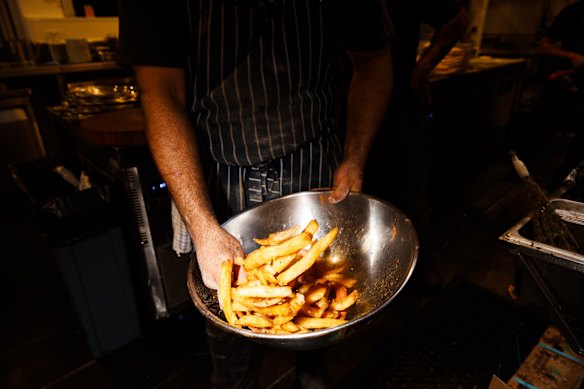 Seasoning the hand-cut chips. 