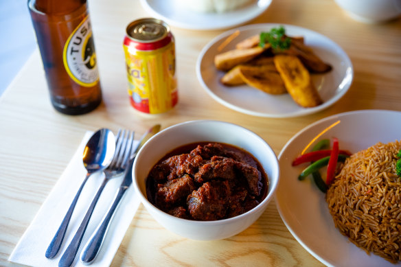 Jollof rice, goat stew and fried plantains.