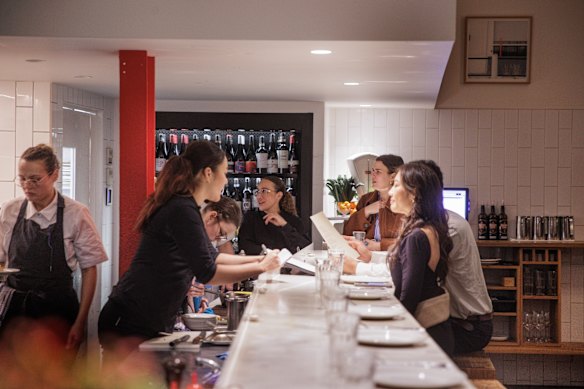 The counter facing the kitchen offers dinner and a show.