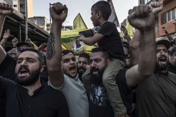 Hezbollah supporters chant slogans against Israel this week while carrying the coffin of a Hezbollah militant killed by the IDF while clashing in southern Lebanon. 