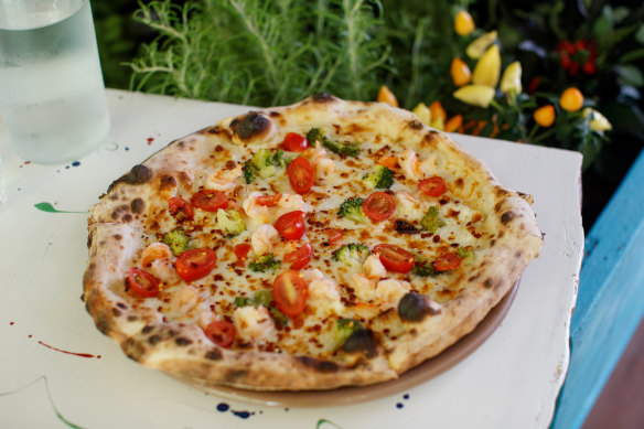 Bianca prawn pizza with garlic oil, king prawns, broccolini, cherry tomato, fior di latte and chilli oil.