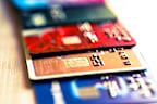 Close up macro color image depicting an abstract view of a collection of debit and credit cards and numeric digits. Room for copy space.