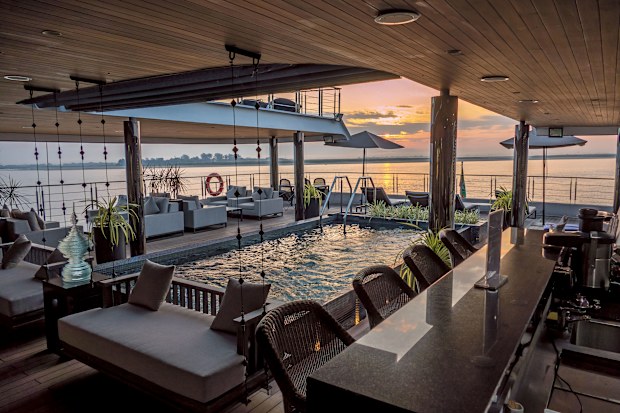 A pool on the deck of a small cruise ship at sunset