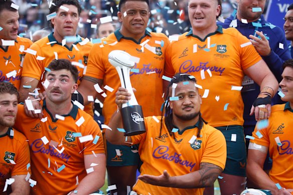 Brandon Paenga-Amosa of the Wallabies holds up the trophy.