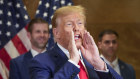 Donald Trump calls out to supporters after his appearance in court on Friday.