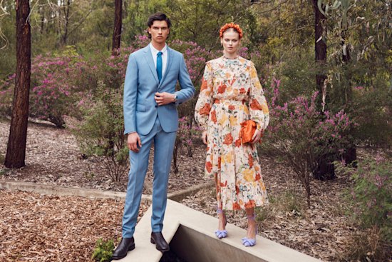 He wears Calvin Klein suit, $599, and dress shirt, $90, from David Jones; Van Heusen tie, $40; Omega “Seamaster Diver 300M 42MM” watch, $8250; R.M. Williams “Comfort Craftsman” boots, $649. She wears Kate Ford “Dahlia” blouse, $395, and skirt, $475; 
La Boheme headband, $28; Arms of Eve pearl and tiger-eye beaded necklace, $120; Loewe Flamenco clutch, $3300; Zara heels, $90.