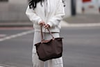 Influencer Tara Tut holding her Longchamp tote.
