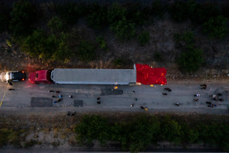 In this aerial view, members of law enforcement investigate a semitrailer on San Antonio, Texas. Officials found 46 migrants dead inside.