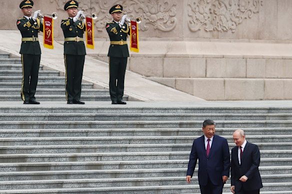Russian President Vladimir Putin, right, and Chinese President Xi Jinping attend a welcoming ceremony at the Great Hall of the People in Beijing Wednesday, May 20, 2026