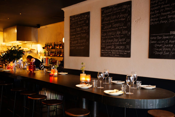 The dining room features a long communal table which runs all the way to the kitchen. 