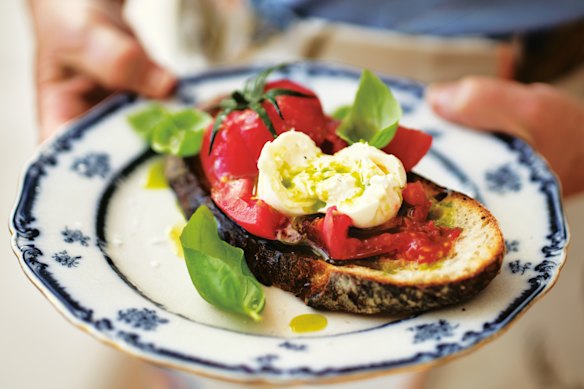 Autumn tomatoes and creamy burrata are piled onto toasted sourdough and finished with basil oil.