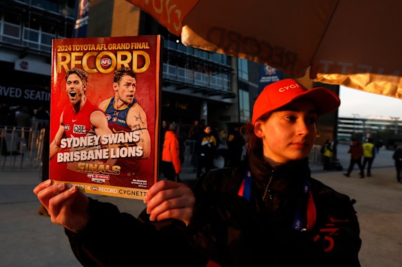 An AFL Record seller is seen outside the M.C.G. before the AFL Grand Final match between Sydney Swans and Brisbane Lions at Melbourne Cricket Ground.