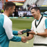 Scott Boland gets his baggy green cap from Josh Hazlewood before the third Test against England at the MCG in 2021.