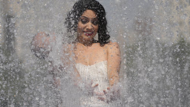 A member of an Australian cabaret and circus troupe cools down in a fountain on the Southbank in Lo<em></em>ndon as a heatwave sweeps across Britain.
