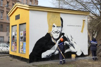 In St Petersburg, workers paint over graffiti of Navalny described as the “hero of our time”.