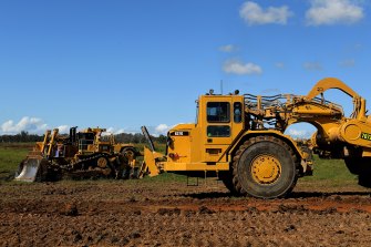 Giant scapers start the major earthworks on the airport site at Badgerys Creek.