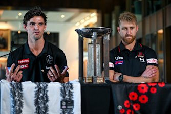 Scott Pendlebury and Dyson Heppell show the jumper designs for Anzac Day 2022.