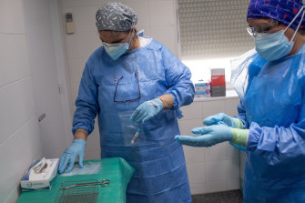 Health workers in Spain prepare to treat coronavirus patients.