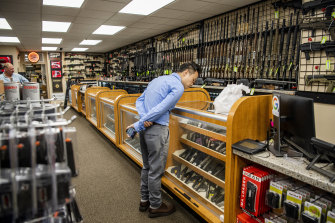 A customer browses the guns on display at SP firearms in Hempstead, New York, on the day of the Supreme Court ruling.