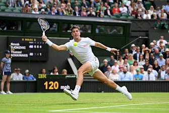 Thanasi Kokkinakis of Australia plays a forehand against Novak Djokovic of Serbia.