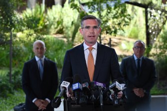 NSW Premier Dominic Perrottet, flanked by Treasurer Matt Kean (left) and Health Minister Brad Hazzard, on Monday announces a support package for major events disrupted by COVID.