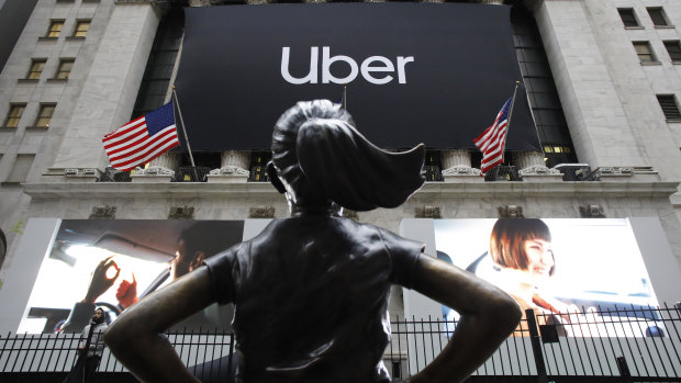 The statue of Defiant Girl stands in front of the New York Stock Exchange where Uber, the world's largest ride-sharing service, held its initial public offering.