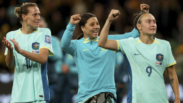 Captain Sam Kerr, flanked by teammates Emily Van Egmond (left)  and Caitlin Foord celebrates the Matildas 4-0 win against Canada on Monday.