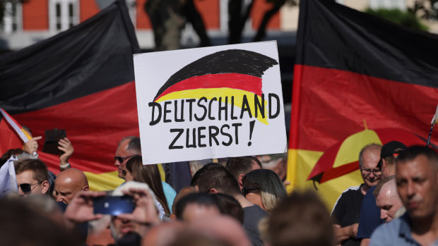 Supporters of the far-right Alternative for Germany political party hold a placard that reads: “Germany First!” at an AfD campaign rally in Thuringia.