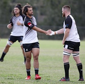 Contact: Karmichael Hunt greets his new teammates before the game.