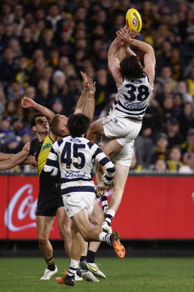Jack Henry flies to mark before converting to pinch the game for Geelong.