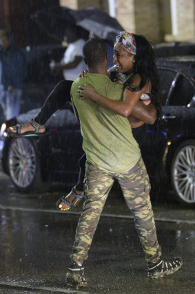 People react at the scene of a shooting in New Orleans.