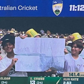 The MCG screen shows fans with a sign reading “We will always miss you Warnie”.