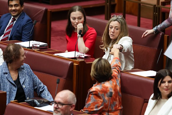 Senator Tammy Tyrrell (in white) sits with Labor for the first time and fist-bumps Dorinda Cox, who also defected to Labor in the past year.