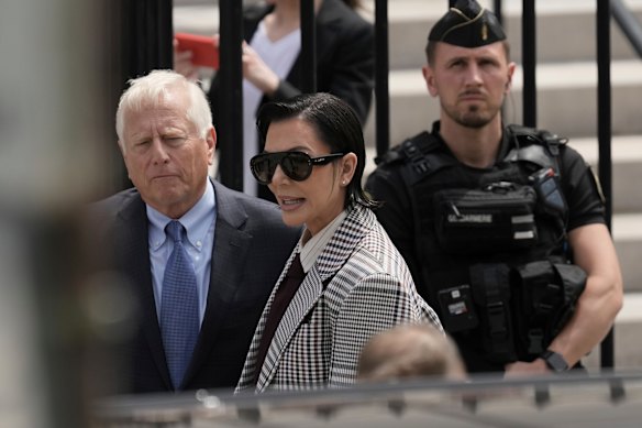Kris Jenner, the mother of Kim Kardashian, speaks with lawyer as she arrives for the trial in Paris.